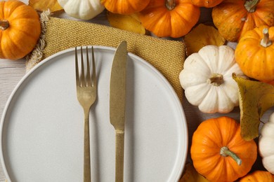 Photo of Happy Thanksgiving day. Beautiful table setting, autumn leaves and pumpkins, flat lay