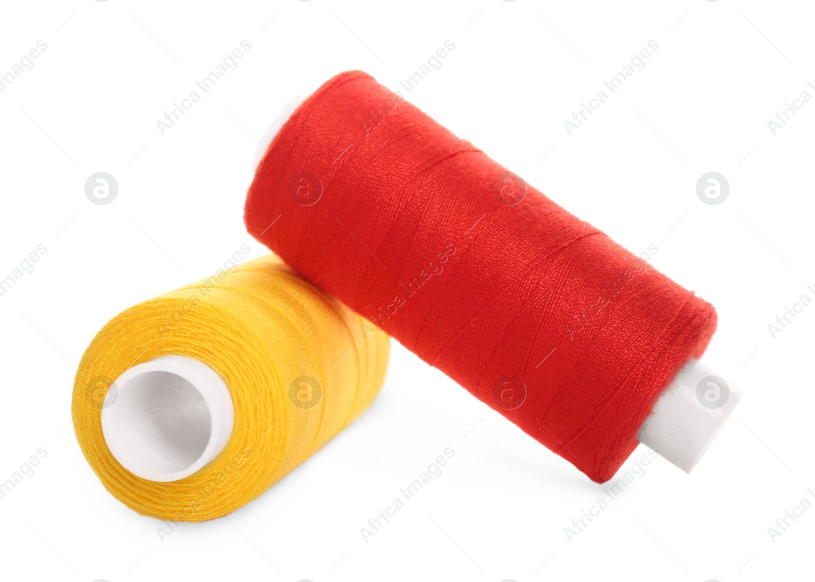 Photo of Different colorful sewing threads on white background