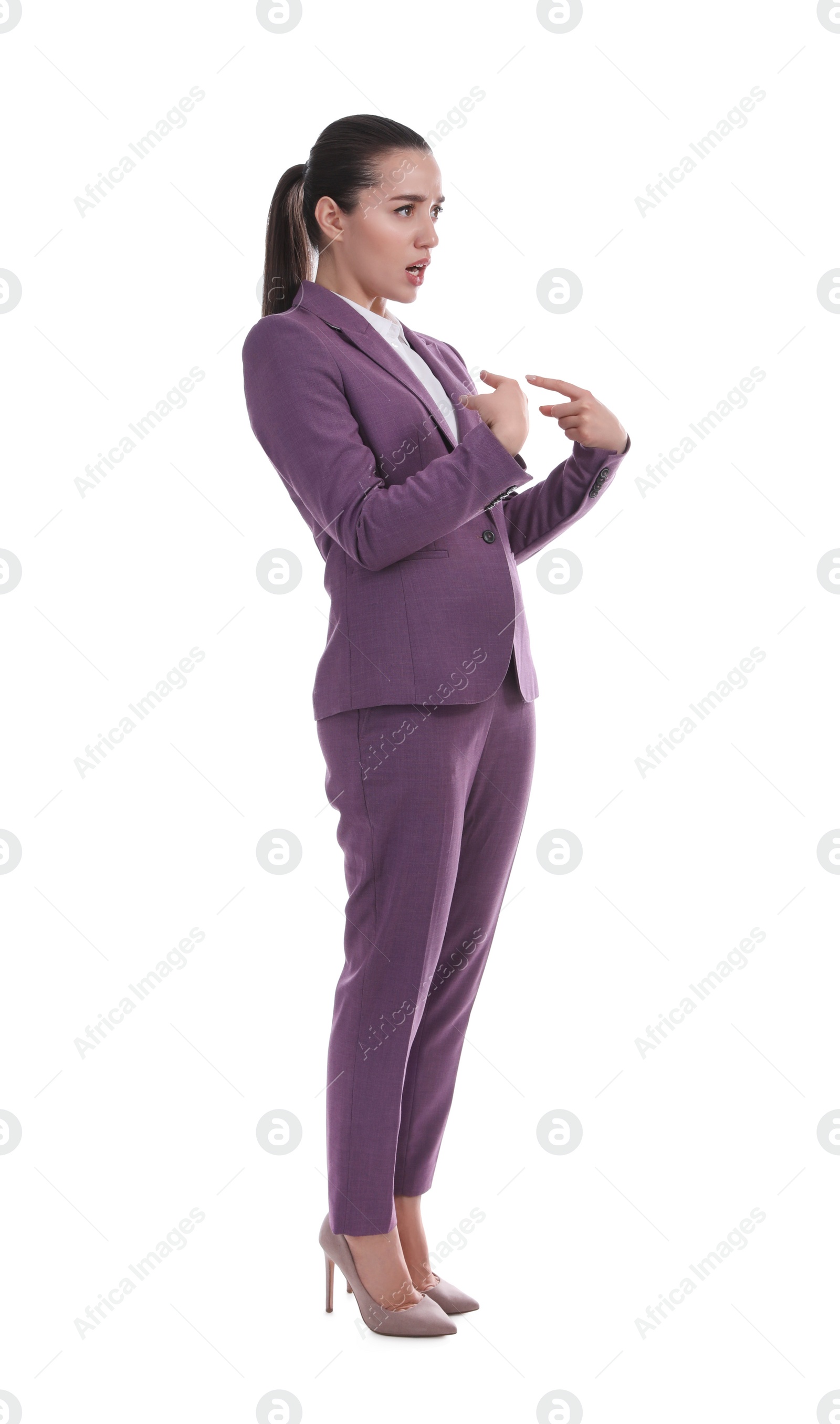 Photo of Woman in suit pointing at herself on white background