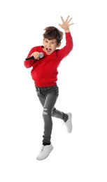 Cute little boy with microphone jumping on white background