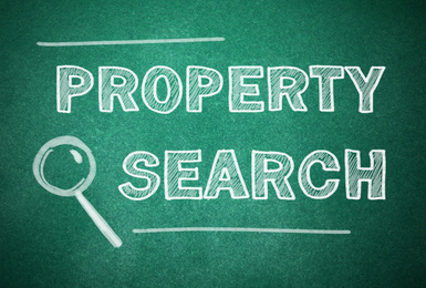 Image of Text Property Search and magnifier illustration on green chalkboard