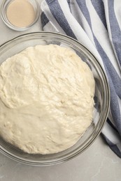 Photo of Fresh dough for cake and dry yeast on marble table, flat lay