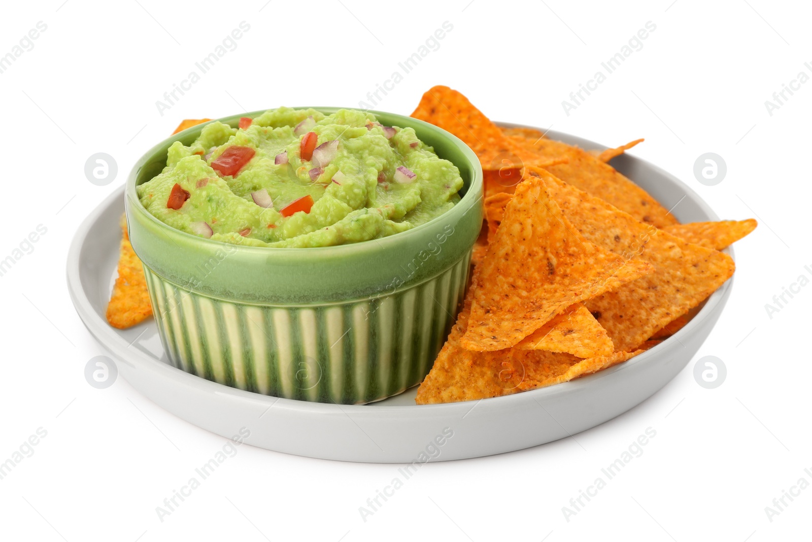 Photo of Bowl of delicious guacamole and nachos chips isolated on white