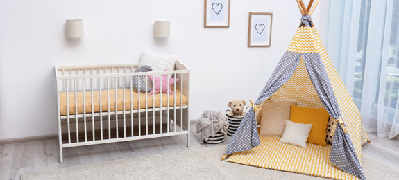 Image of Baby room interior with comfortable crib and play tent. Banner design