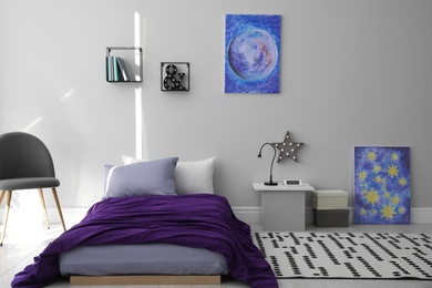 Modern teenager's room interior with comfortable bed and stylish design elements