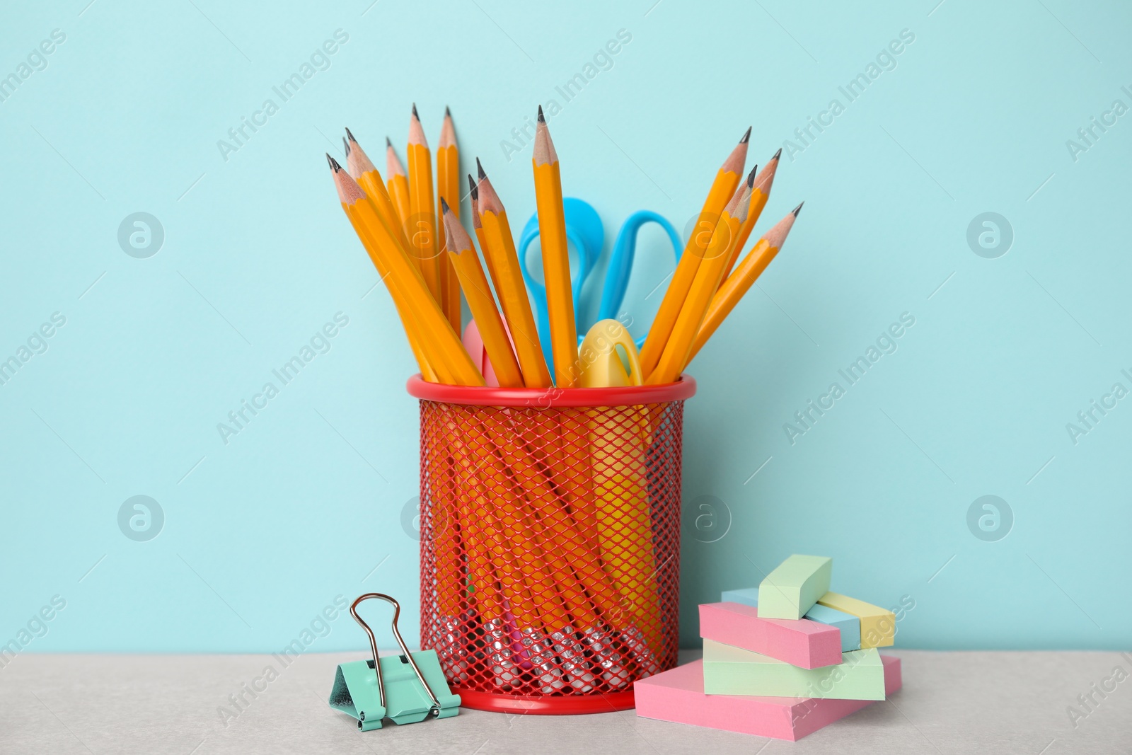 Photo of Different school stationery on table against light blue background. Back to school