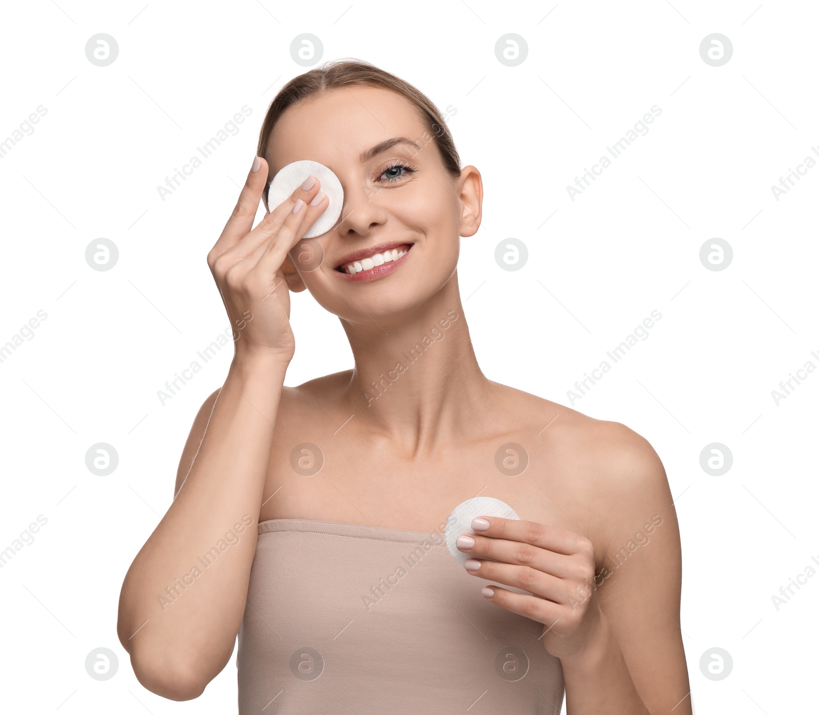 Photo of Smiling woman removing makeup with cotton pads on white background