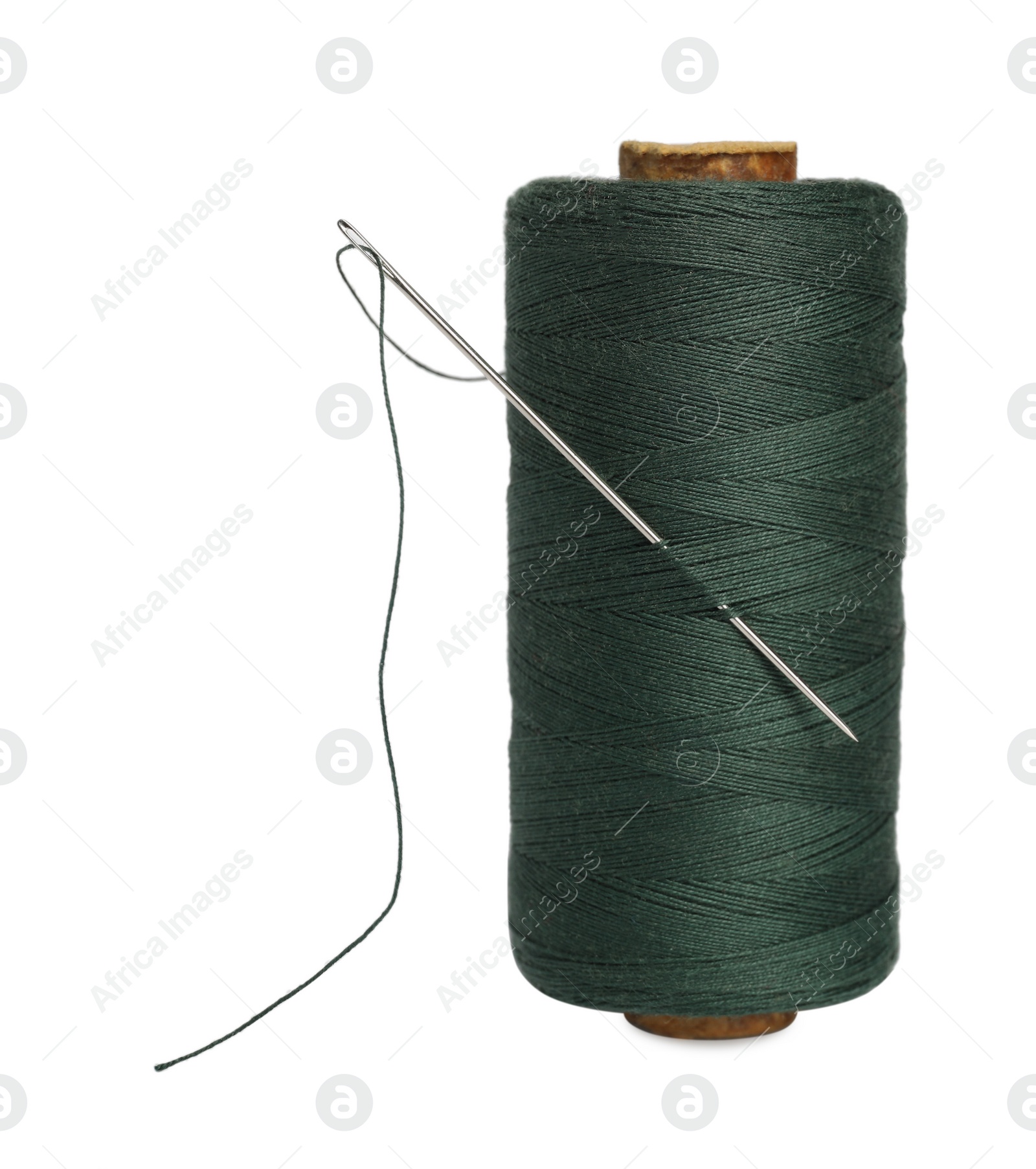 Photo of Green sewing thread with needle on white background