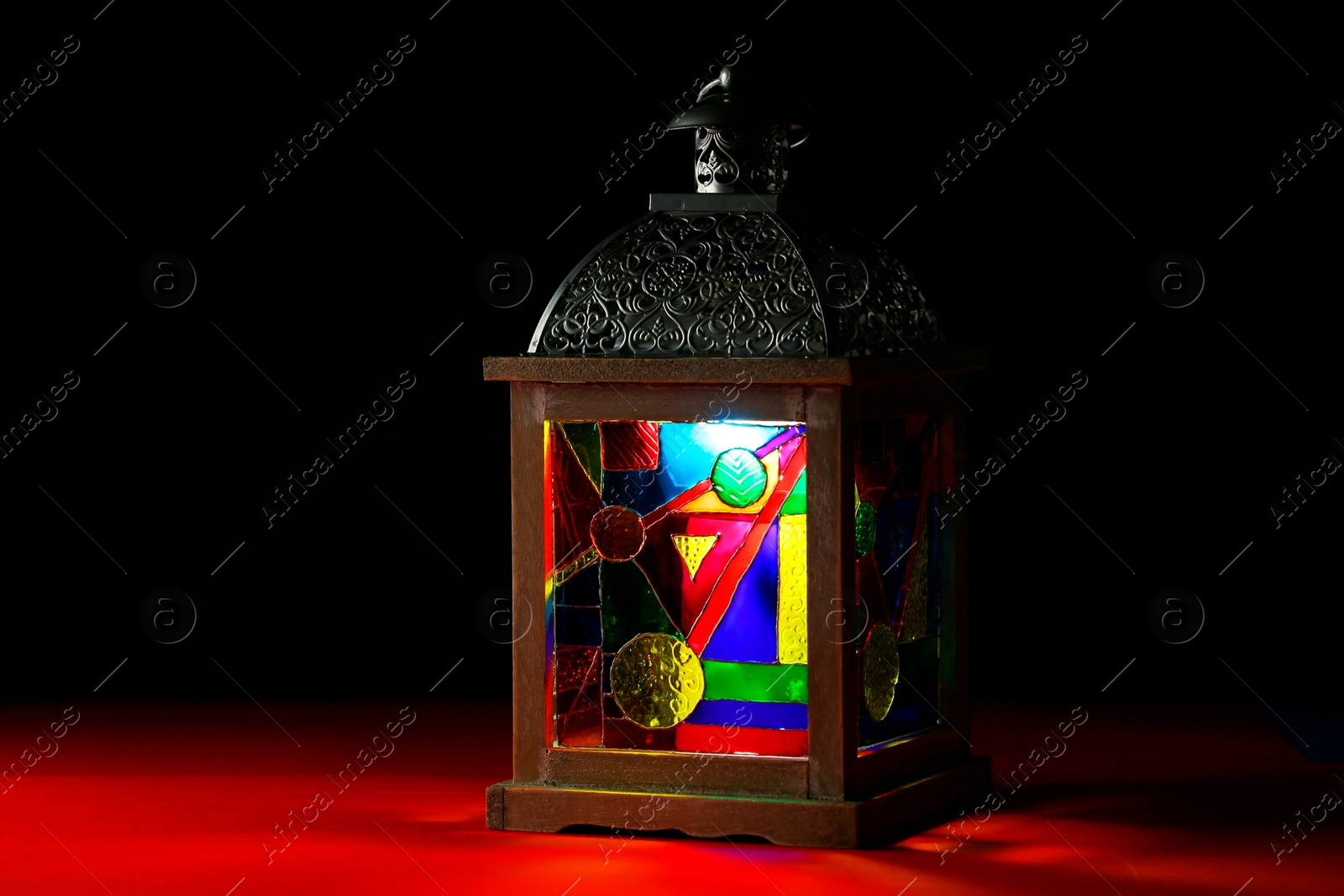 Photo of Decorative Arabic lantern on table against dark background