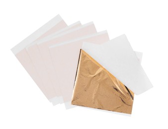 Photo of Many edible gold leaf sheets on white background, top view
