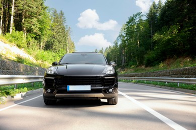 Photo of Picturesque view of asphalt road with modern car