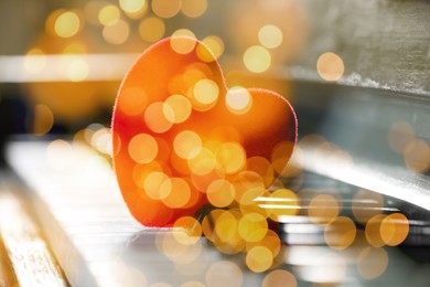 Christmas and New Year music. Piano with heart, bokeh effect