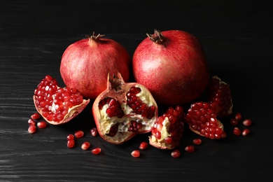 Ripe red pomegranate fruits on dark background