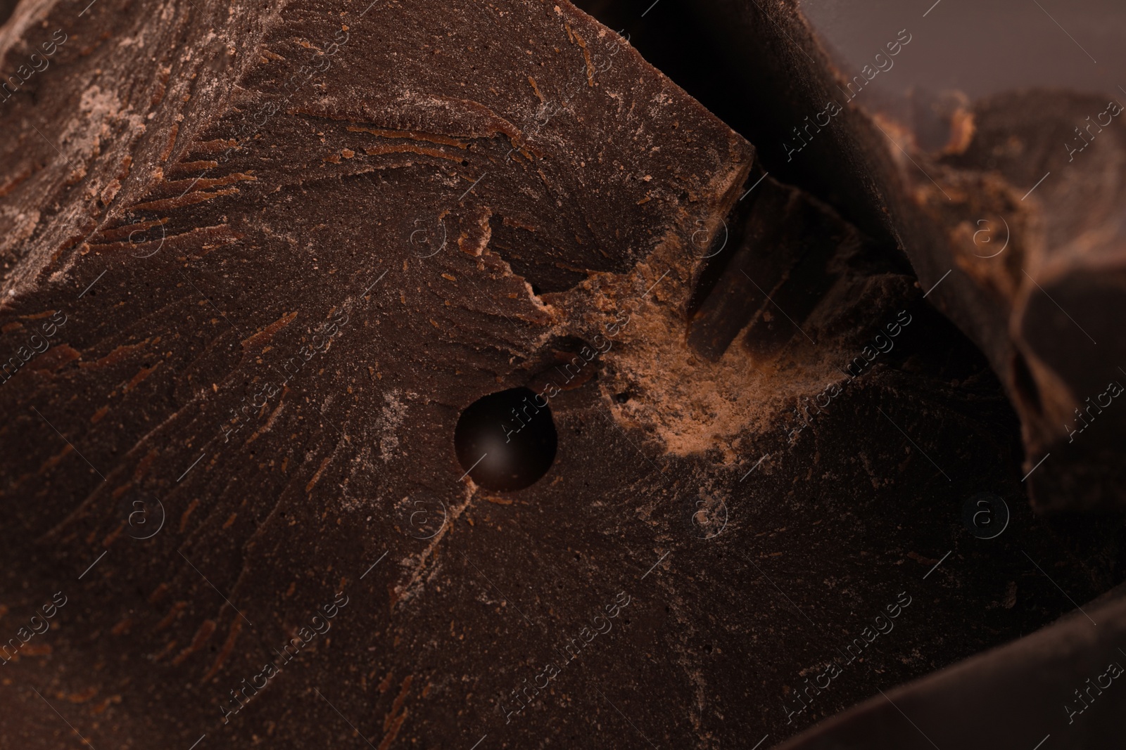 Photo of Pieces of dark chocolate as background, closeup