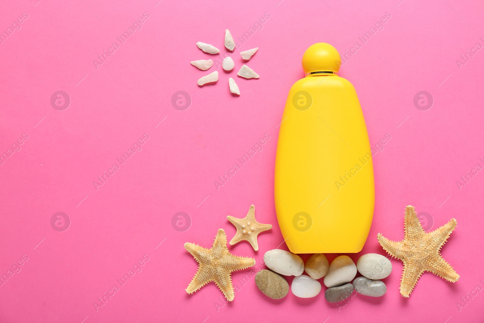 Photo of Suntan cream, seashells and sun made of marble pebbles on pink background, flat lay. Space for text