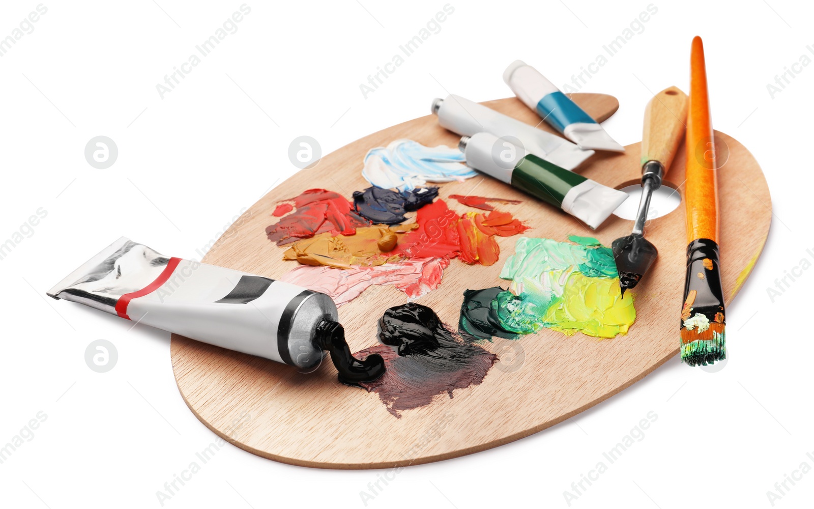 Photo of Wooden palette with oil paints and tools on white background