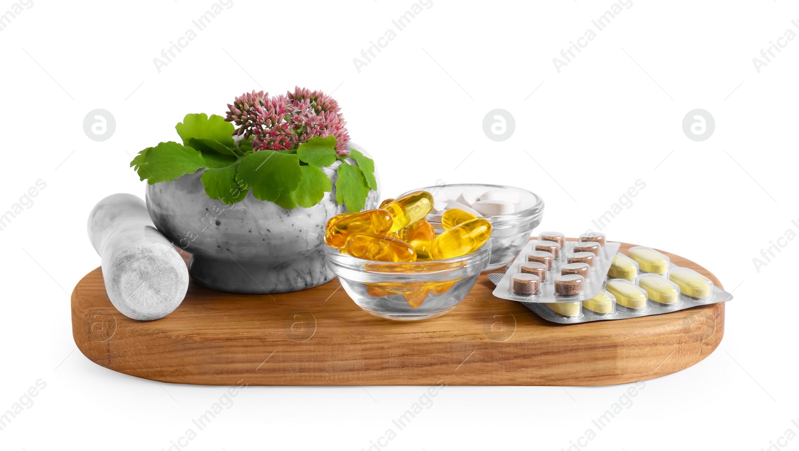 Photo of Board with mortar, fresh herbs and pills on white background