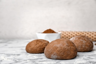 Photo of Raw rye dough on table against light background