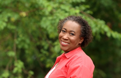 Portrait of happy African-American woman in park