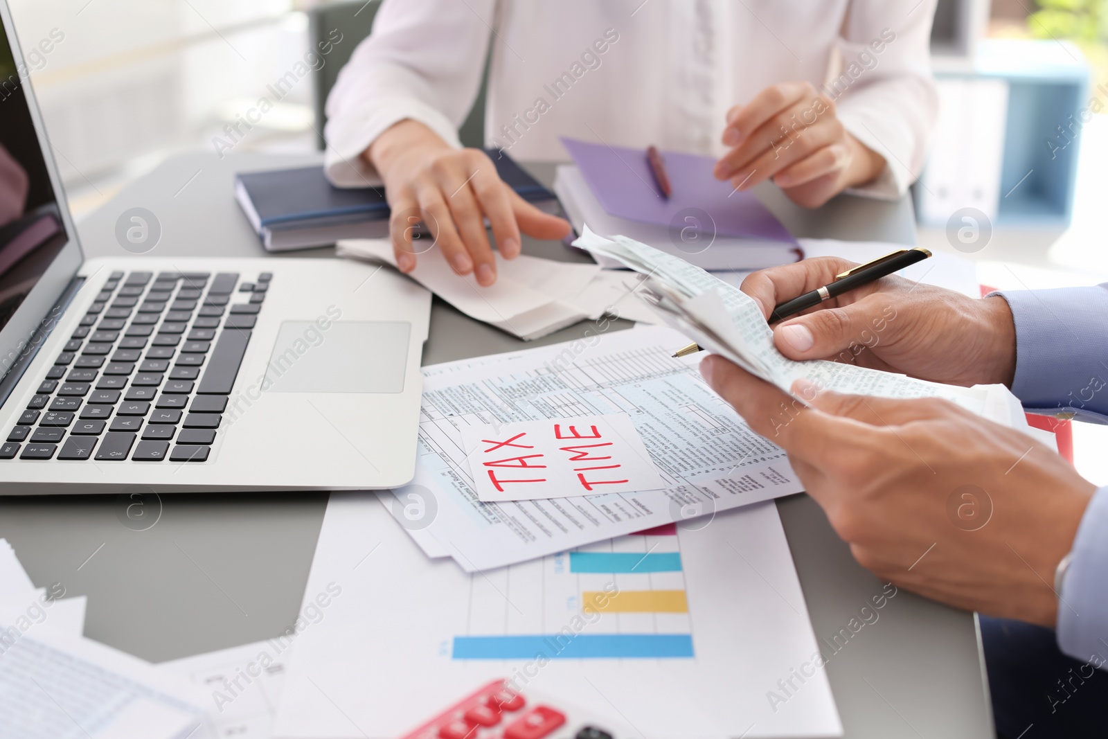 Photo of Tax accountants working with documents at table