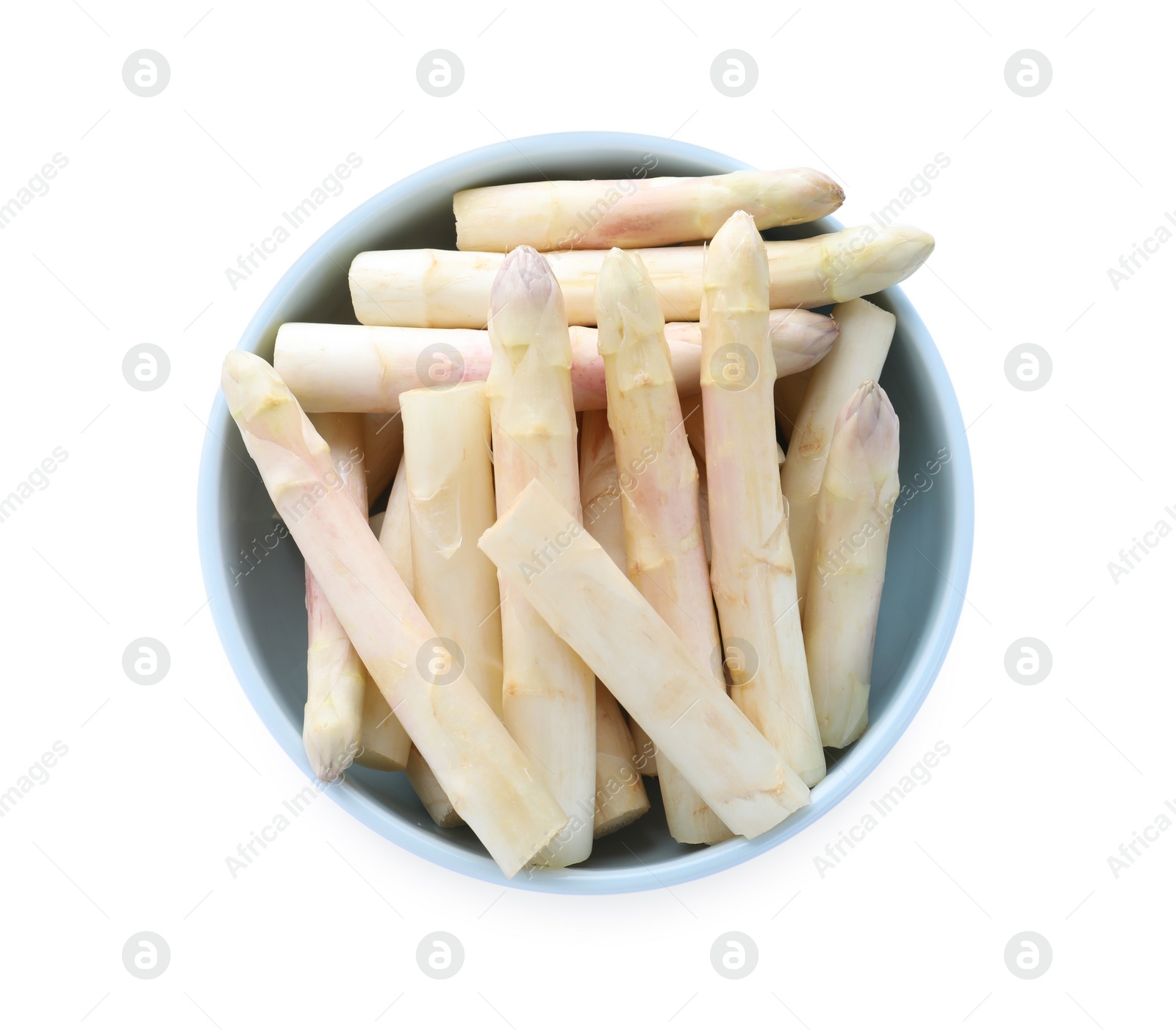 Photo of Fresh raw asparagus in bowl isolated on white, top view