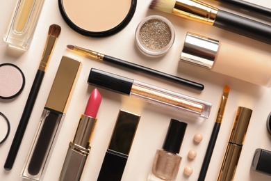 Photo of Different luxury makeup products on color background, flat lay