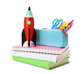 Photo of Bright toy rocket and school supplies on white background