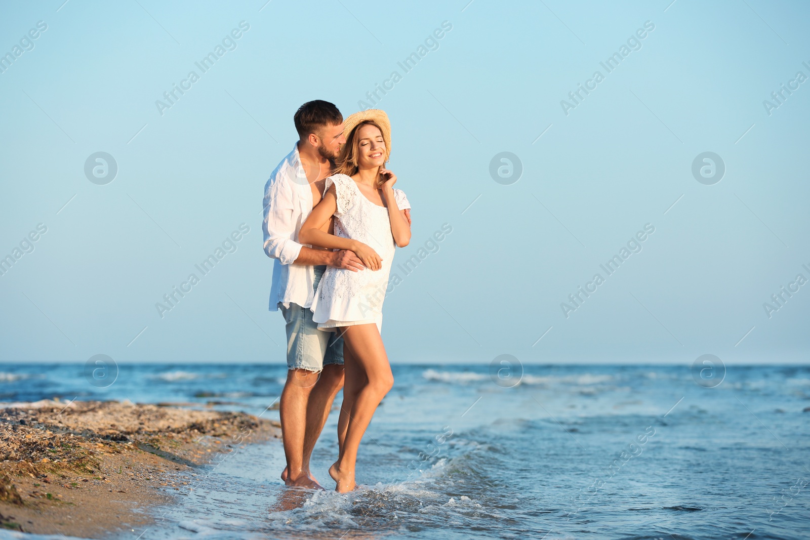 Photo of Young couple spending time together on beach