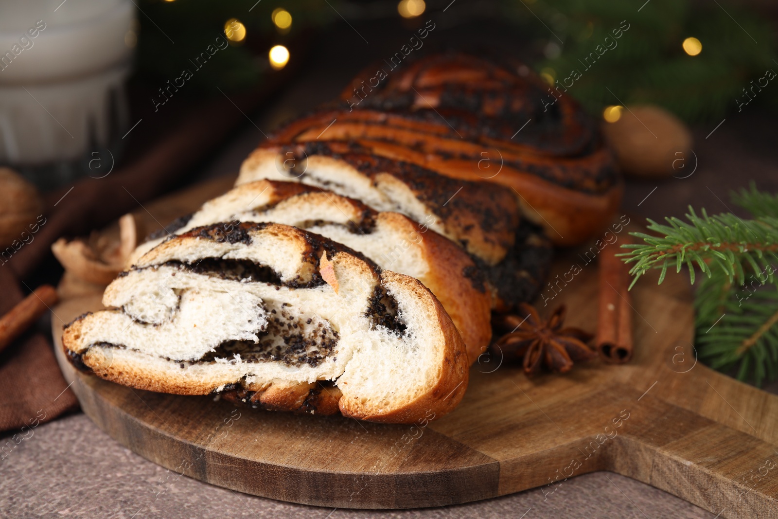 Photo of Cut poppy seed roll on textured table, closeup. Tasty cake