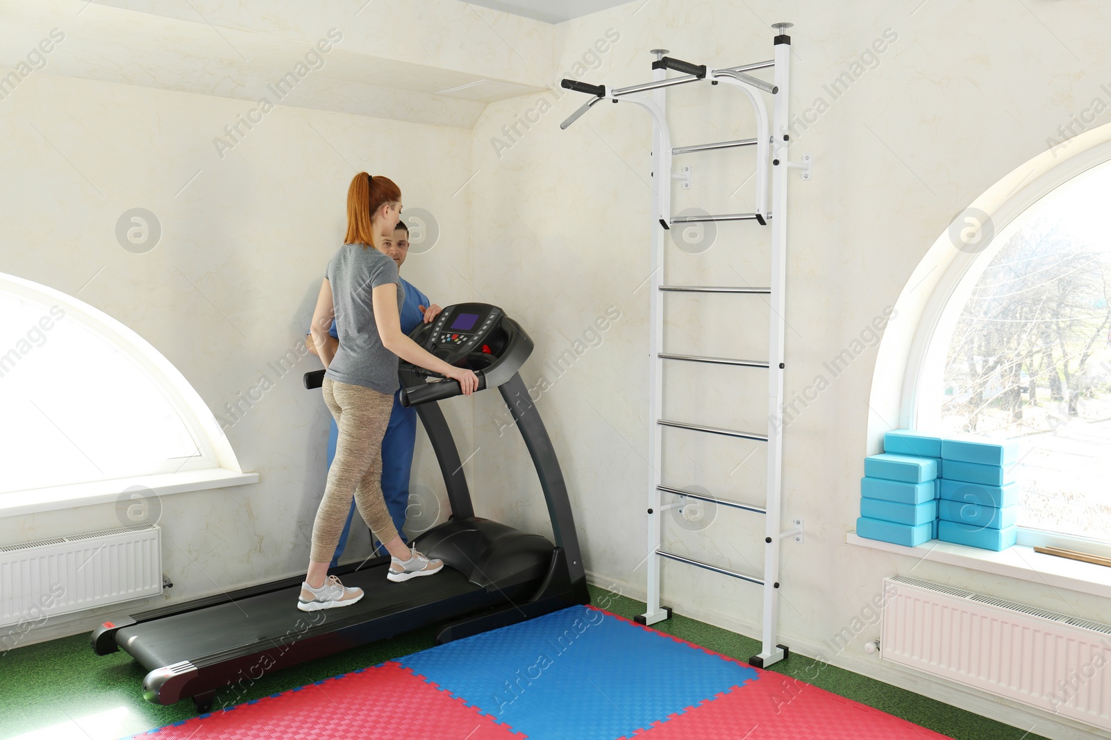 Photo of Patient exercising under physiotherapist supervision in rehabilitation center