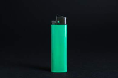 Stylish small pocket lighter on black background