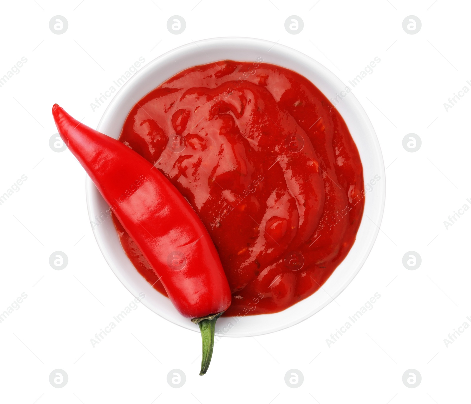 Photo of Bowl with red sauce and fresh chili pepper isolated on white, top view