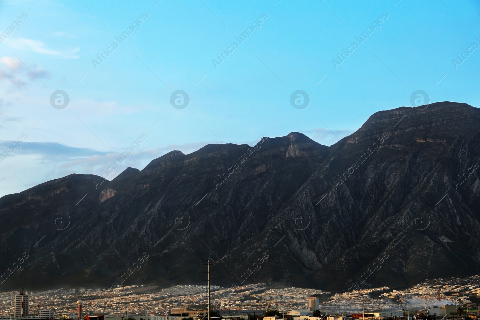 Photo of Picturesque view of city near beautiful mountains and sunset sky