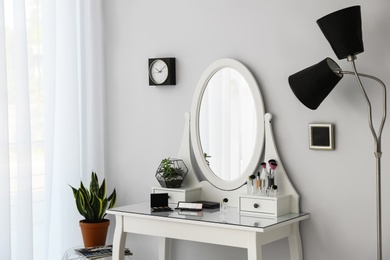 Dressing table with mirror in stylish room interior