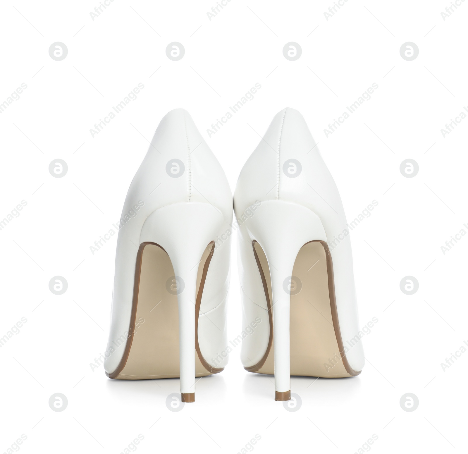 Photo of Beautiful classic wedding shoes on white background, back view