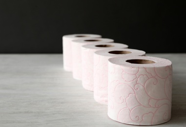 Row of toilet paper rolls on light table