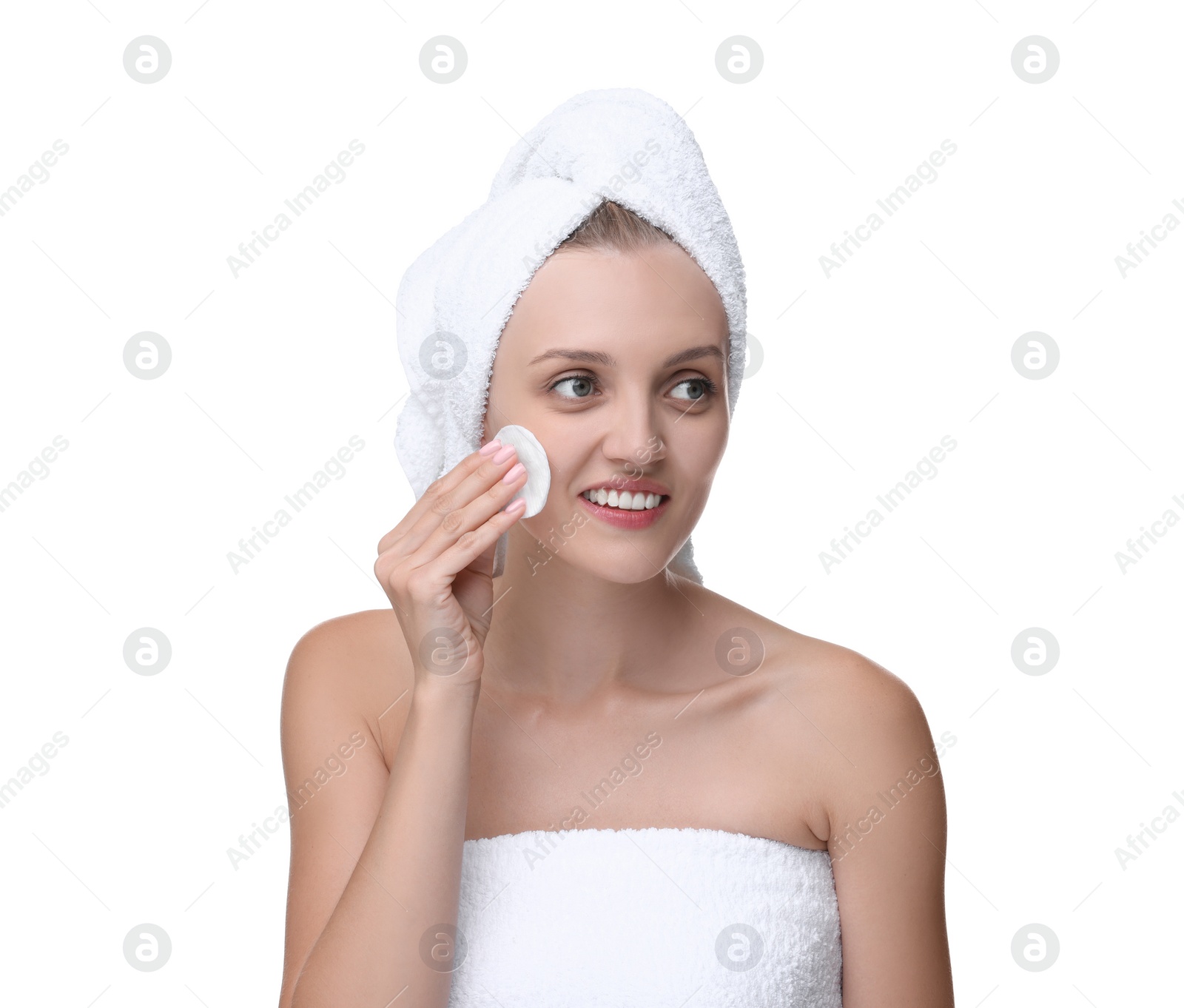 Photo of Young woman cleaning her face with cotton pad on white background