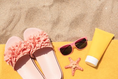 Photo of Different beach accessories on sand, flat lay. Space for text