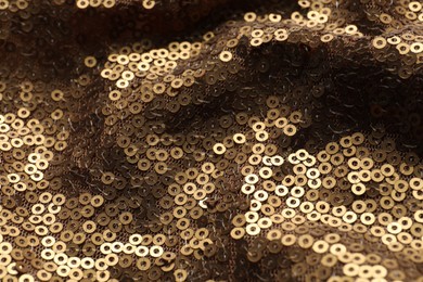 Beautiful golden sequin fabric as background, closeup