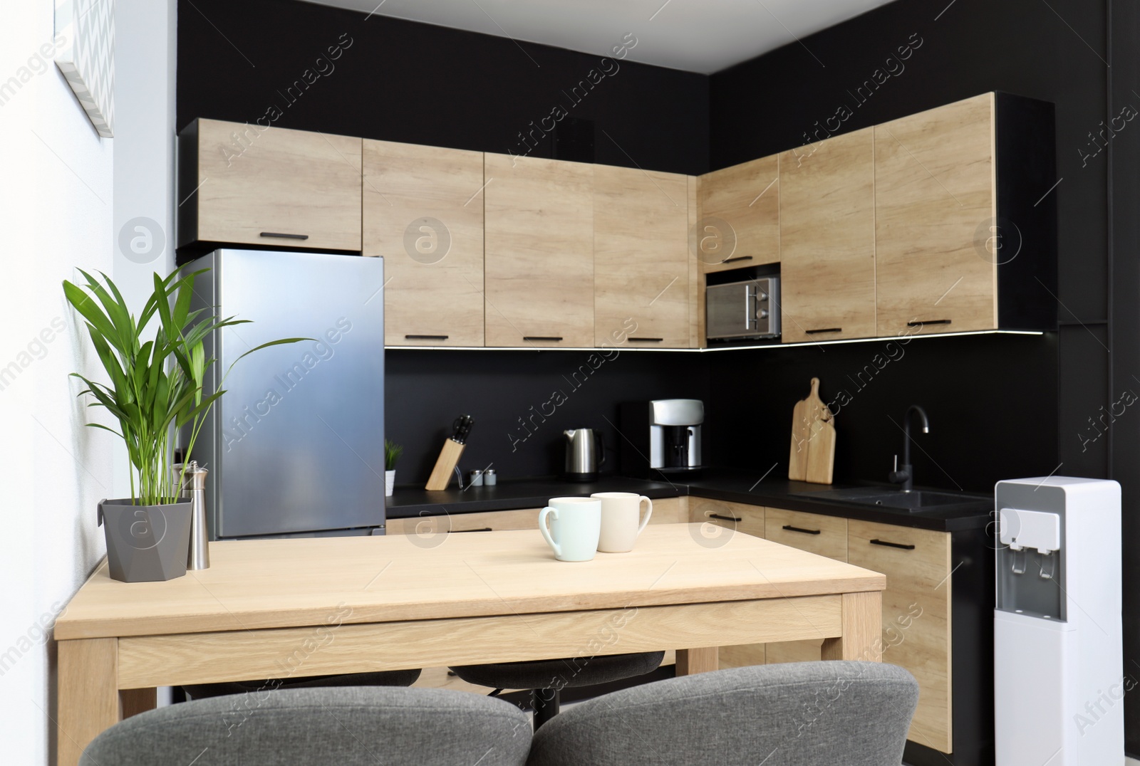 Photo of Cozy modern kitchen interior with new furniture and appliances