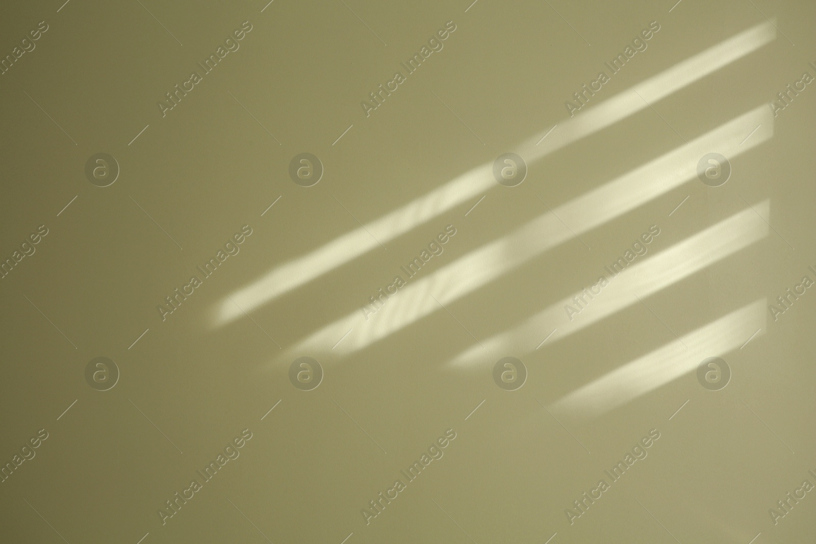 Photo of Light and shadow from window on beige wall indoors