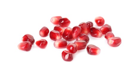 Photo of Pile of tasty pomegranate grains isolated on white