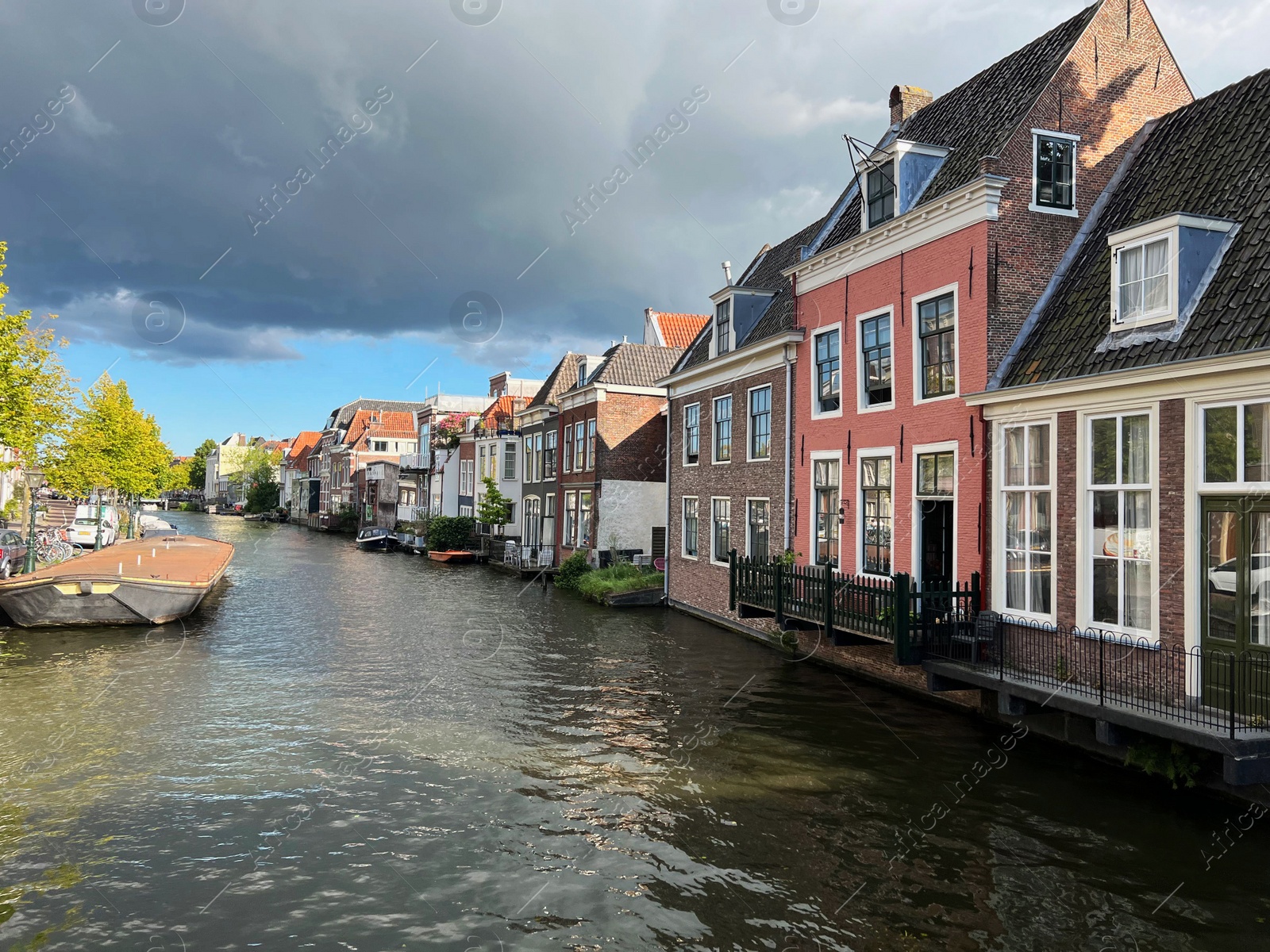 Photo of Beautiful view of buildings near canal in city under cloudy sky