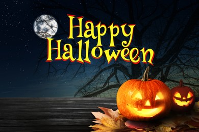 Image of Happy Halloween. Spooky Jack O`Lantern pumpkins on wooden table under full moon