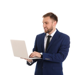 Happy young businessman using laptop on white background