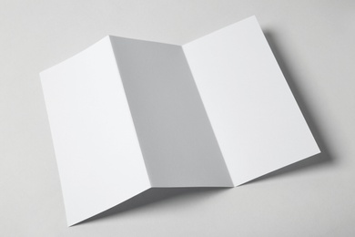 Blank brochure on white background, above view. Mock up for design