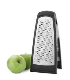 Stainless steel grater and fresh apples on white background