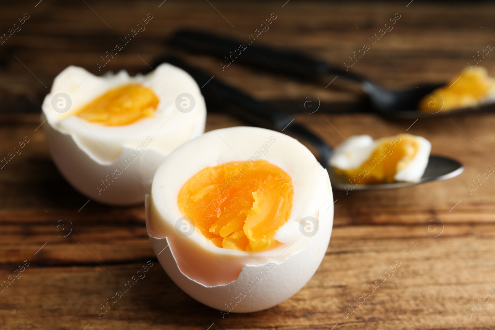 Photo of Tasty boiled chicken eggs on wooden table, closeup