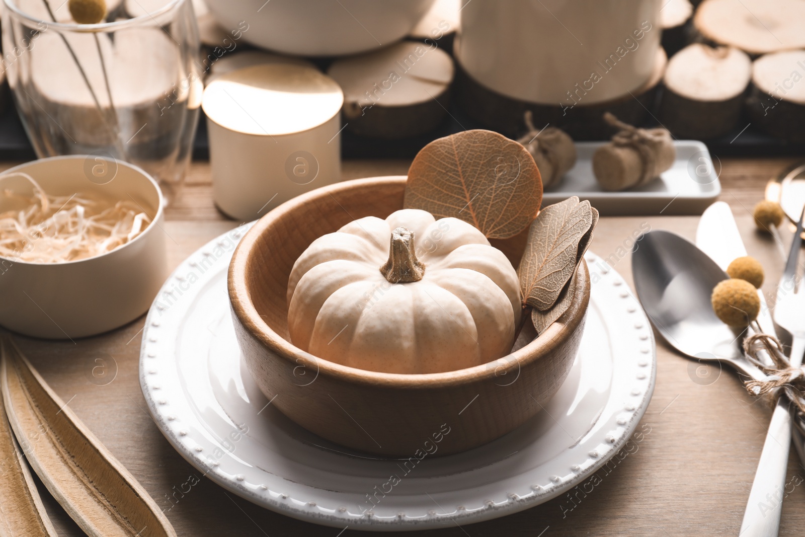 Photo of Autumn table setting with pumpkin and decor on wooden background