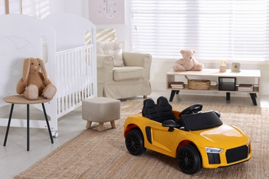 Photo of Yellow car in room at home. Child's toy